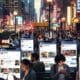 People using social apps in an urban setting, illustrating social platforms acting like search tools