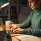 Person writing SEO content in a cozy workspace