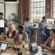 Team of contractors engaging on social media in a modern workspace