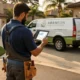 Home services contractor reviewing exclusive leads on tablet beside branded work truck